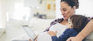 mom-pregnant-on-tablet-300